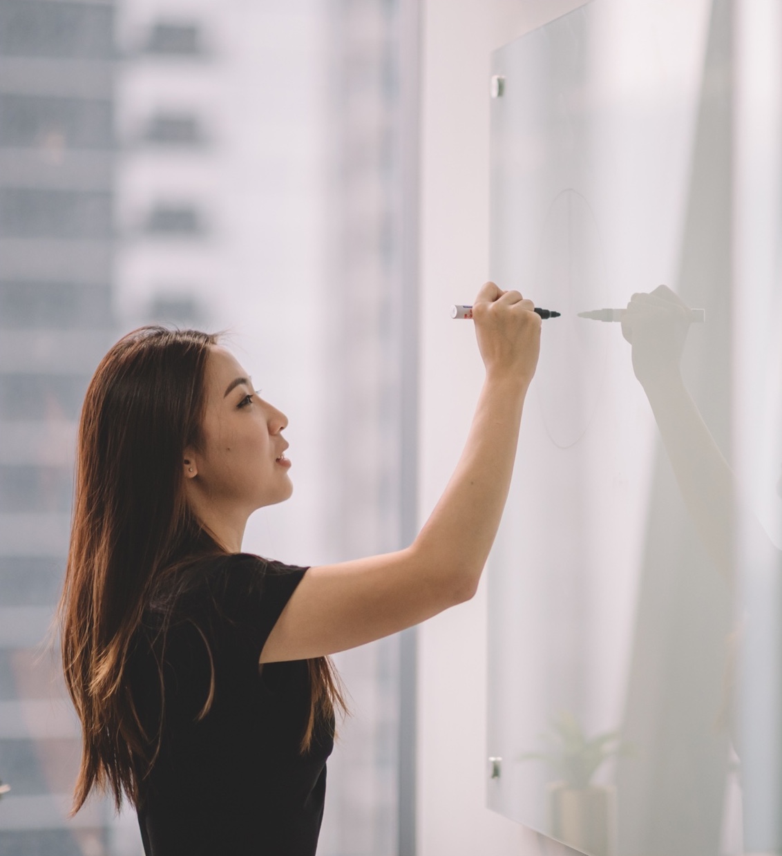 woman writing on whiteboard