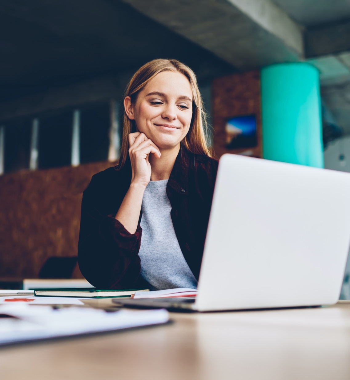 a young businesswoman looking at a laptop