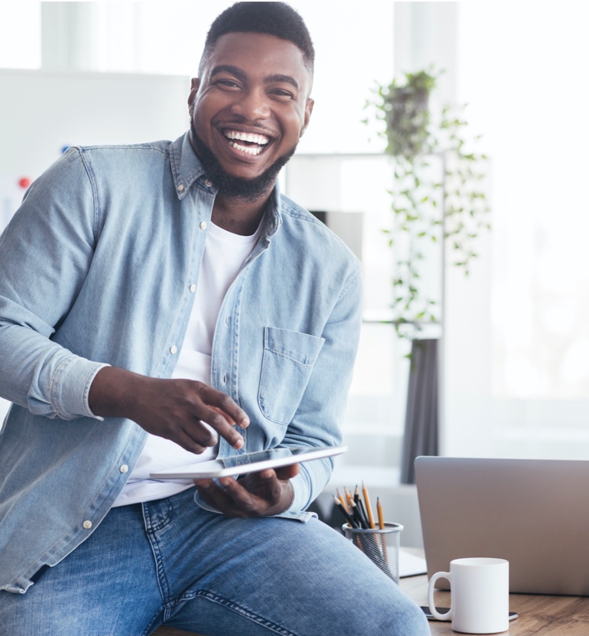 man laughs with smartphone in hand