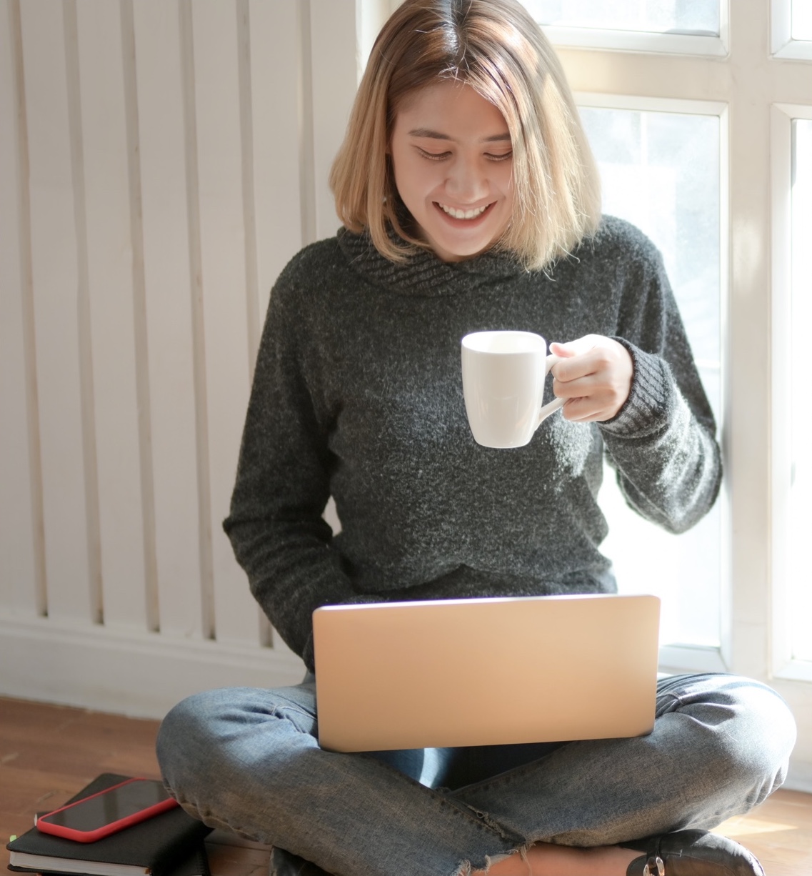 woman with coffee on a laptop