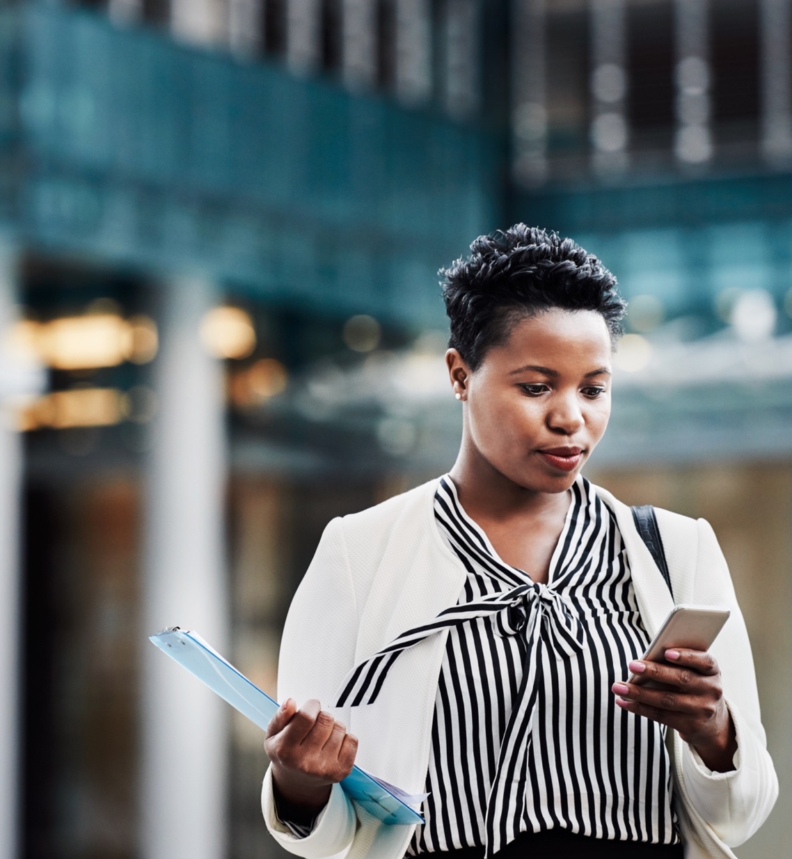 a woman checks her phone on the go