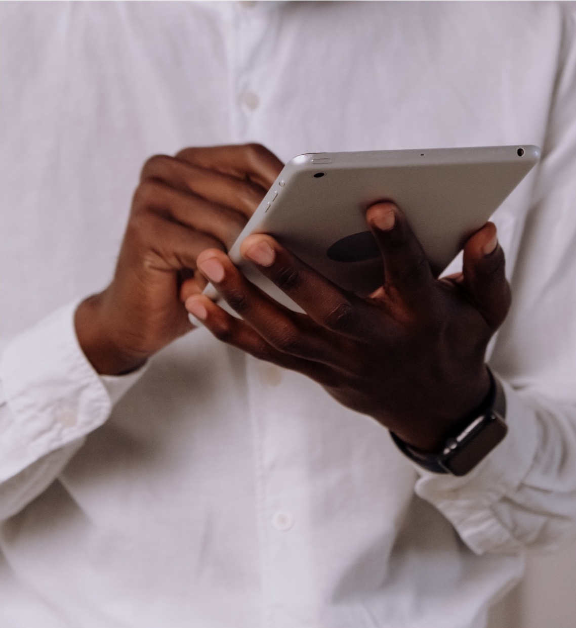 hands holding a tablet