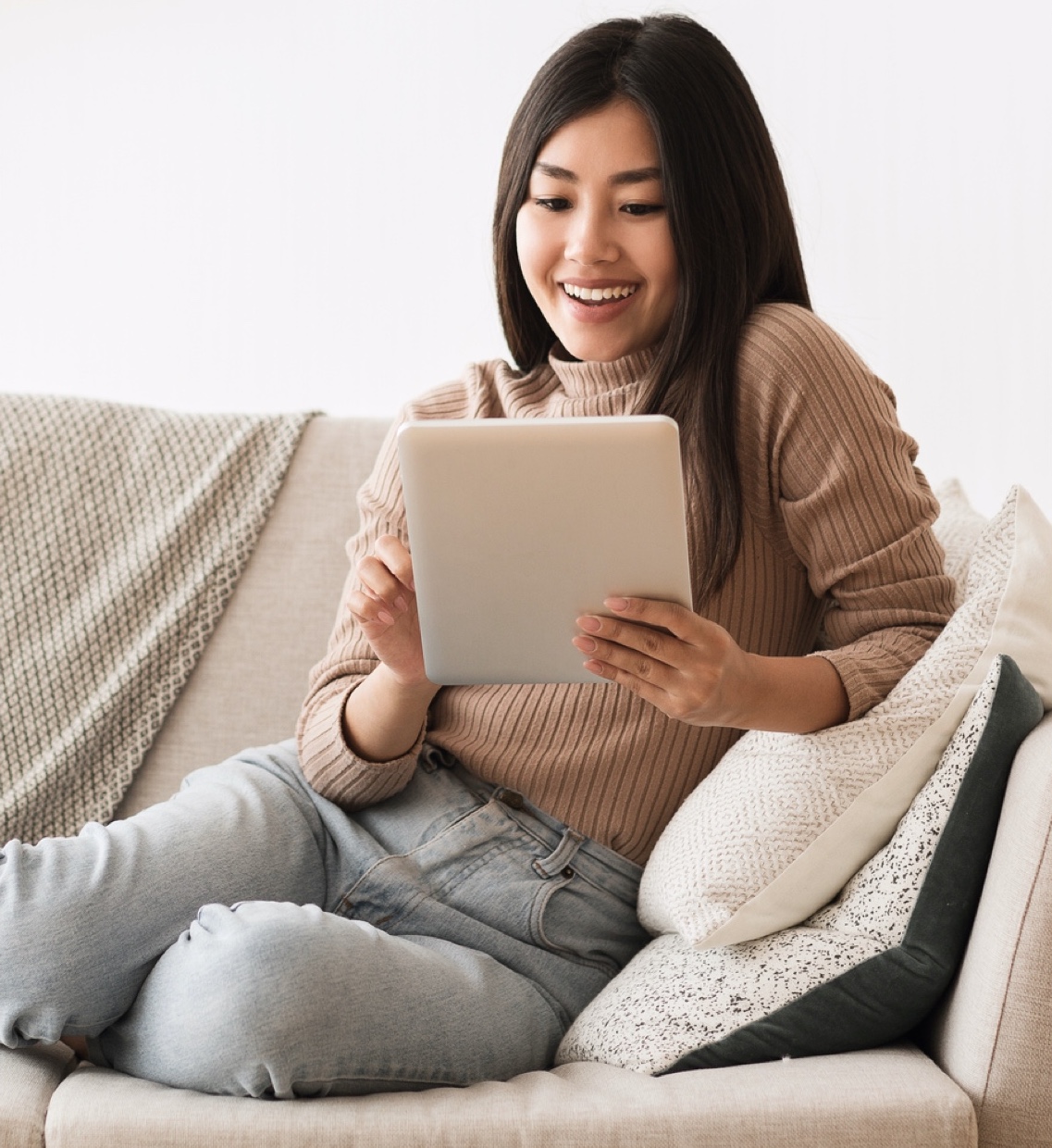 woman on a couch with a tablet