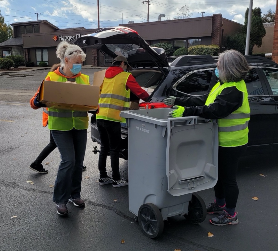 volunteers load a cart with supplies